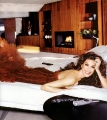 Teri Hatcher laying on the bed in hot a dress