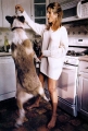 Jennifer Aniston is feeding her dog in the kitchen