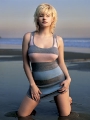 Elisha Cuthbert posing on the beach at the sunset